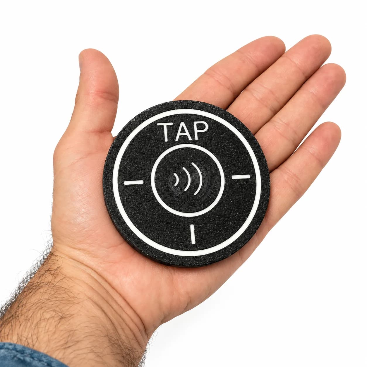 Tip Puck resting in a hand to show its size